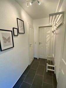 a hallway with a white door and a tile floor at Bernsteinsucher in Norden