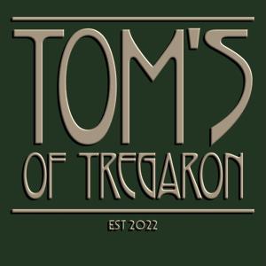 a green sign with the words tufts of trafalgar at Tom's of Tregaron in Tregaron