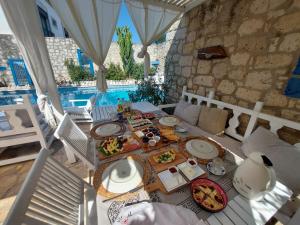a table with food on it in a room with a pool at 1882 Hotel in Alacati