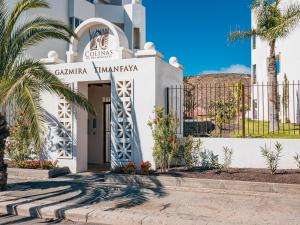 a building with a palm tree in front of it at Gazmira 21 DELUXE 2B in Palm-mar
