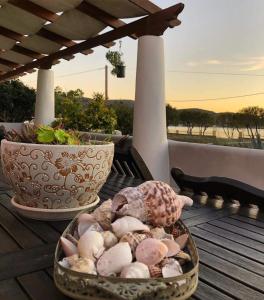 two baskets of shells on a table on a deck at Leros Sunset Apartments in Gourna