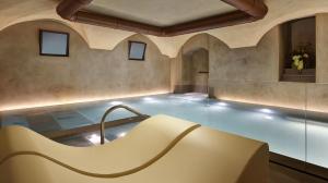 a swimming pool with a tub in the middle of a room at Palazzo Portinari Salviati Residenza D'Epoca in Florence