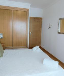 a bedroom with a bed with two towels on it at S. Soares Riviera Flat in Portimão