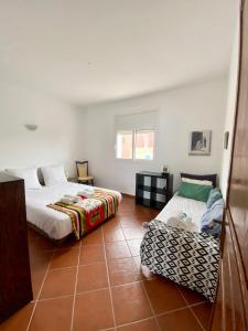 a bedroom with two beds and a chair in it at Panoramica Atlantic Villa Souss-Massa in Rbat