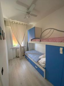 a bedroom with two bunk beds and a window at CASA TERESA in Lido Adriano