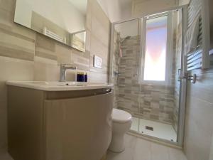 a bathroom with a toilet and a sink and a shower at CASA TERESA in Lido Adriano