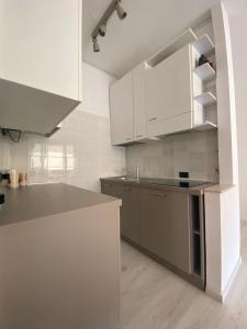 a kitchen with white cabinets and a gray counter top at CASA TERESA in Lido Adriano