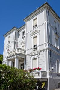 - un bâtiment blanc avec des balcons et des fleurs dans l'établissement Esedra Hotel, à Rimini