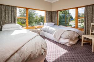 a bedroom with two beds and a window at Grand View - Te Anau Holiday Home in Te Anau