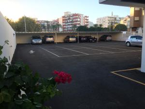 a parking lot with a bunch of cars parked in it at Apartamento vacacional Jávea in Jávea +5 photos