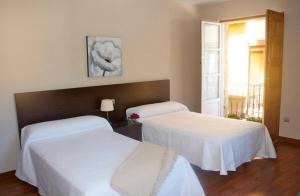 Postel nebo postele na pokoji v ubytování Hostal El Palacio
