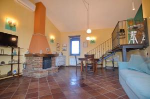 a living room with a couch and a fireplace at Agriturismo La Torre dell'Oliveto in Agello