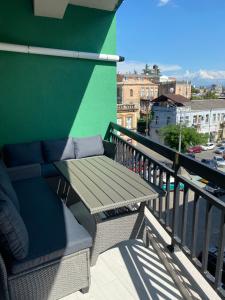 a balcony with a bench and a green wall at Home № 1 in Kutaisi