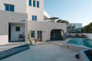 a house with a swimming pool next to a building at Elements Cozy Suites Pyrgos in Pyrgos