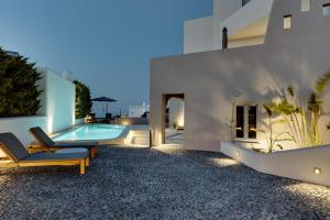 a villa with a swimming pool at night at Elements Cozy Suites Pyrgos in Pyrgos