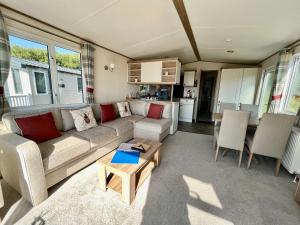 a living room with a couch and a table at Forget Me Not Caravan - Littlesea Haven Holiday Park, Weymouth in Wyke Regis
