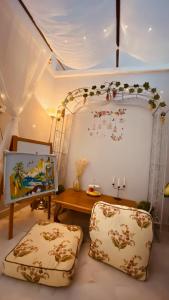 a living room with a table and two pillows at Angel Spa Garden's Homestay in Ipoh