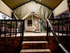 a tent with a bed in the back of it at Lions Rock Rapids - Luxury Tented Camp in Hazyview