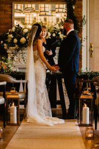 a bride and groom are standing at the alter at The Great House, Sonning, Berkshire in Reading