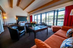 a living room with a couch and a table at Hotel Le Grand Pavois in Fécamp