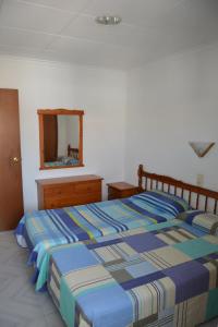 a bedroom with a bed and a dresser and a mirror at APCOSTAS Europa in Blanes +17 photos