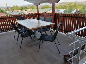 a wooden table and chairs on a patio at Borche Apartments in Bogdanci