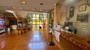 a restaurant with a counter in the middle of a room at Tabinoyado Yakurai Rinsenkan in Osaki