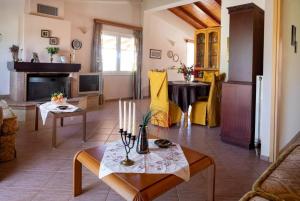 a living room with a table and a fireplace at Ktima Abella ✩ Organic Garden ✩ Absolute Privacy in Élos
