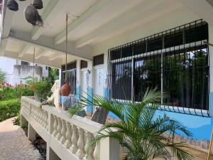 a house with a balcony with a plant on it at Villa Mar Sosua in Sosúa