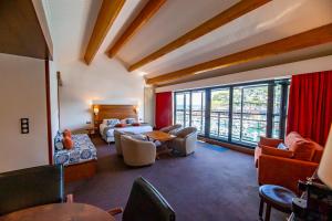 a large living room with a bed and a couch at Hotel Le Grand Pavois in Fécamp