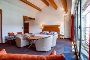 a bedroom with a bed and a table and chairs at Hotel Le Grand Pavois in Fécamp