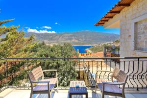 a balcony with chairs and a view of the water at Atalante Hotel in Kas