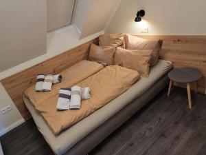 a bed with towels on it in a room at FeWo-Brak in Norden