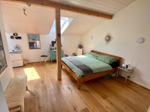 a bedroom with a bed and a large window at Otium-Oberhofen in Oberhofen am Thunersee