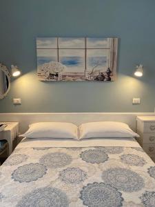 テルモリにあるLe Stanze del Centroのベッドルーム1室(ベッド1台付)が備わります。壁には絵画が飾られています。