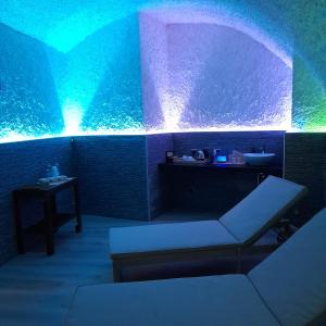 a room with a couch and a blue and green lighting at Bike Hotel Touring Gardone Riviera & Wellness in Gardone Riviera