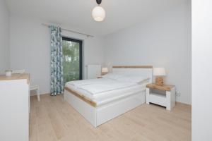 Łóżko lub łóżka w pokoju w obiekcie Jantar Apartamenty Siedem Wysp