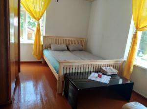 a small bedroom with a bed and a table at Salisburg Residence in Mazsalaca