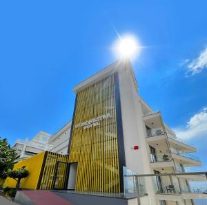 a building with the sun on top of it at Dorchester Hotel in Sarandë