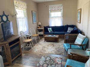 a living room with a blue couch and a tv at Great Location! 4 Bedroom 2 bath sleeps 10 in Cape May