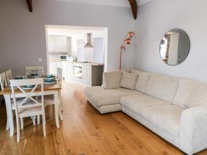 a living room with a couch and a table at Ramsey Cottage in Haverfordwest