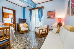 a living room with a couch and a table at Ioanna Villa in Skala Marion