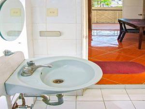 a white sink in a bathroom with a mirror at OYO 679 Ddd Habitat Pension House in Cagayan de Oro