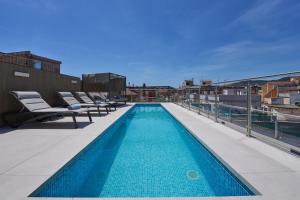 a swimming pool on the roof of a building at Catalonia Barcelona 505 in Barcelona