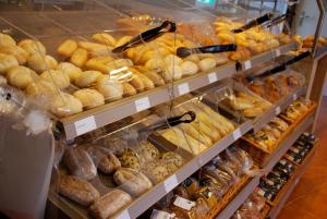 a display case filled with lots of different types of bread at EuroParcs De Zanding in Otterlo