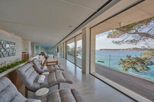a living room with a view of the ocean at Four Seasons Astir Palace Hotel Athens in Athens