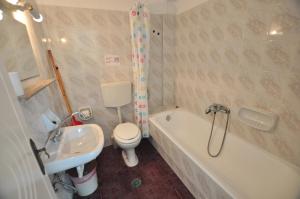 a bathroom with a sink and a toilet and a tub at Antigoni Apartments in Acharavi