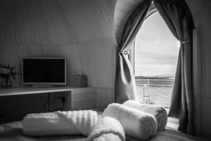 a living room with a window and a tv at “Whitekirk” Rock & Castle Escapes in Whitekirk