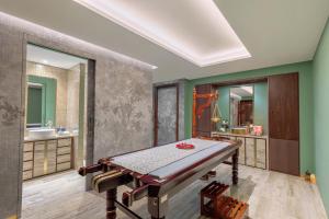 a bathroom with a table and a sink at Taj Exotica Resort & Spa, The Palm, Dubai in Dubai