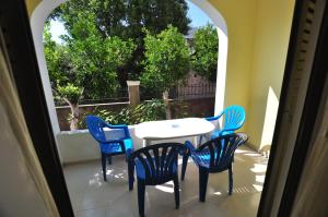 a table and chairs on a patio with a window at Antigoni Apartments in Acharavi +40 photos